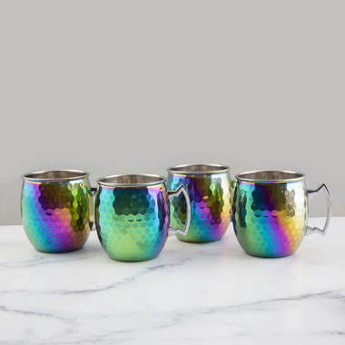Four iridescent mugs on a marble surface with a white background